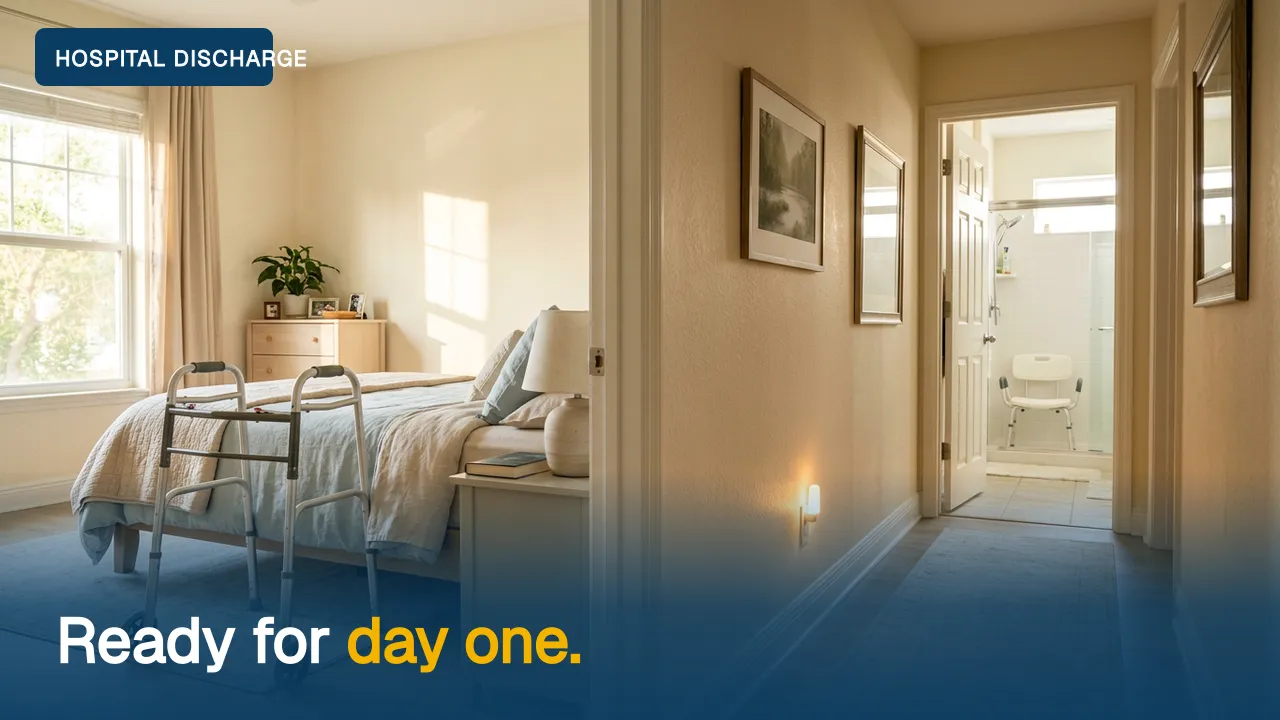 A walker beside a bed, with a lit path to an open bathroom door where a shower chair waits.